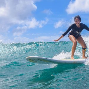 girl surfing on lesson in waikiki